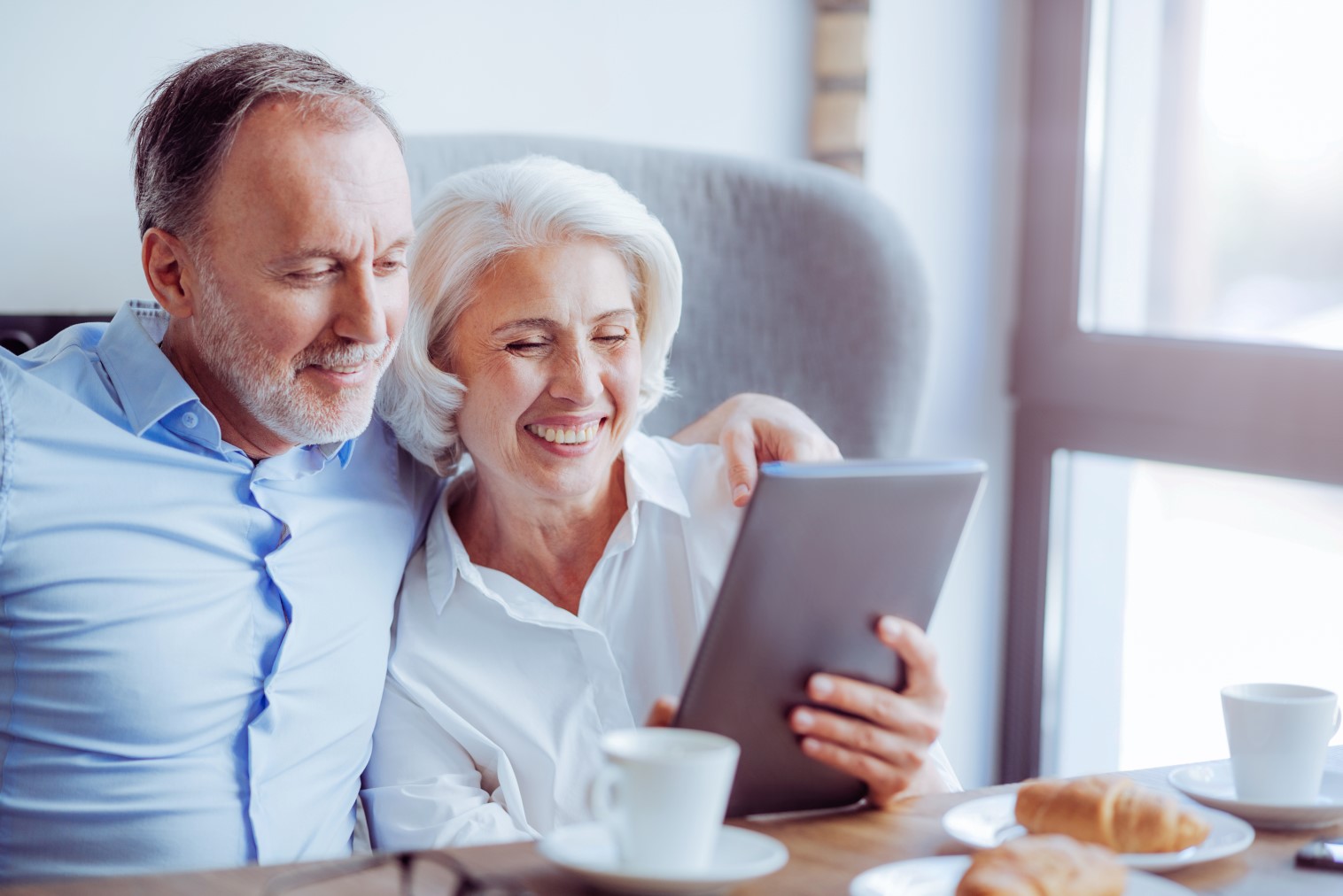 Positive senior loving couple resting in the cafe